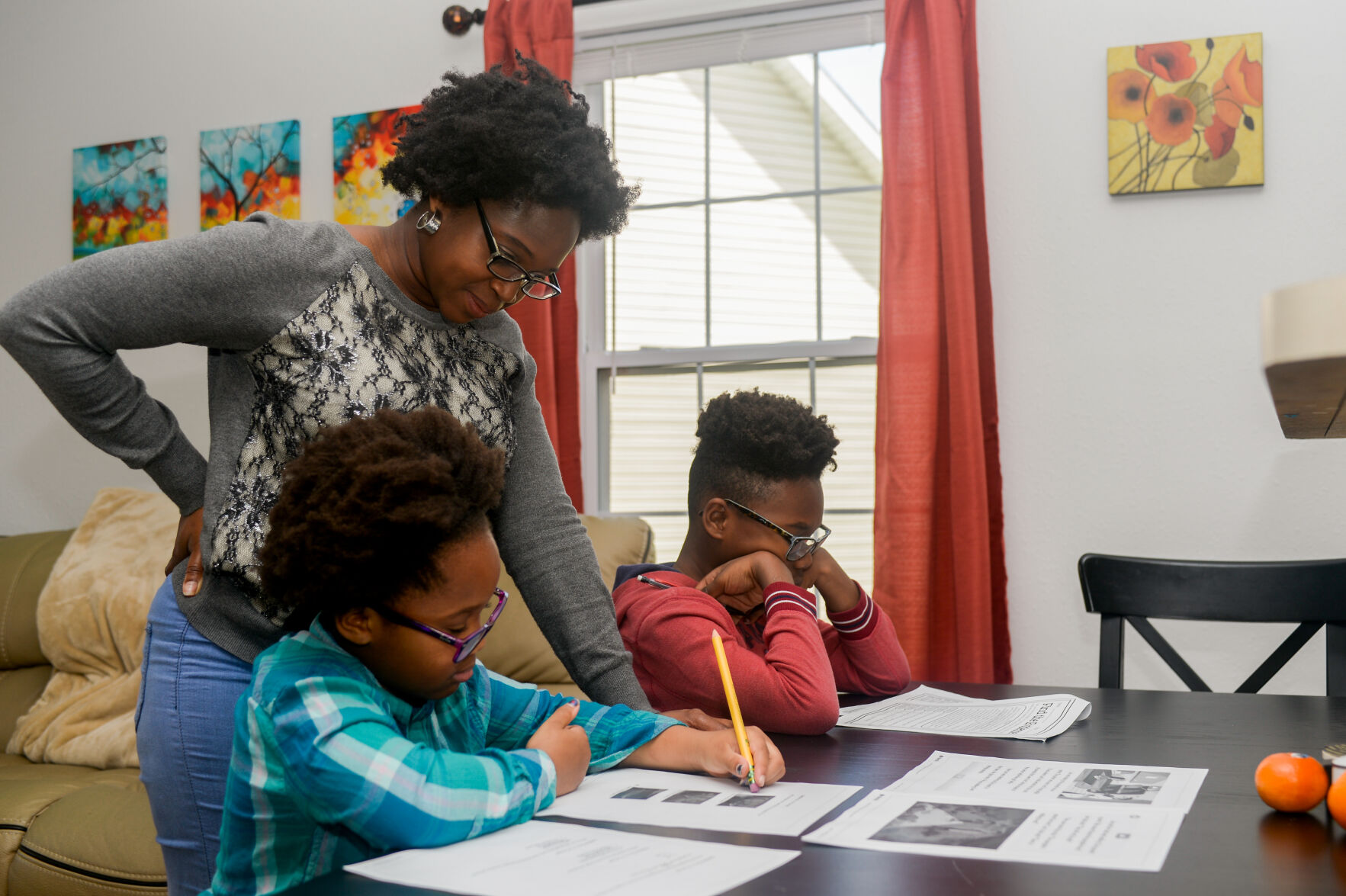 Marjorie Williams helps her kids with school